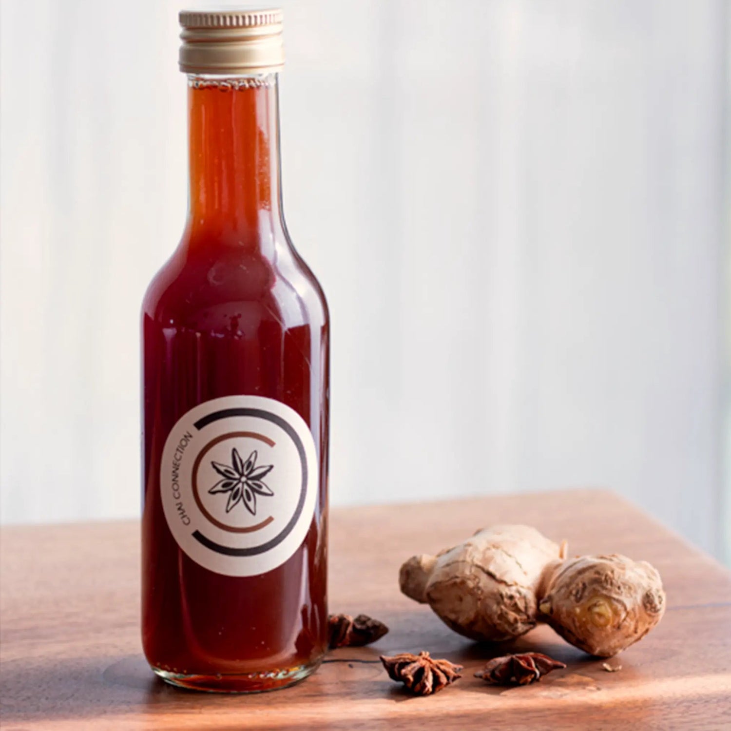 Glas mit Chai Connection Chai-Konzentrat, dekoriert mit frischem Ingwer und Sternanis – handgemachtes Chai Konzentrat aus natürlichen Zutaten für Zuhause, Cafe, Bar und Gastronomie.